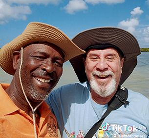 Antigua bird watching tour guide with guest at the beach looking for birds